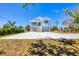 Inviting two-story home with a metal roof, double garage, and ample outdoor space at 1141 Andrews St, Englewood, FL 34224