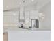 Bright kitchen featuring stainless steel appliances, custom range hood, and quartz countertops at 1141 Andrews St, Englewood, FL 34224