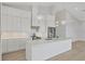 Modern kitchen with white cabinetry, stainless steel appliances, and a large center island at 1141 Andrews St, Englewood, FL 34224