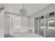 Living area with chandelier and sliding glass doors to screened lanai at 1141 Andrews St, Englewood, FL 34224