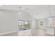 Open living room with a vaulted ceiling, sliding glass doors and an open connection to the kitchen at 1141 Andrews St, Englewood, FL 34224