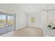 Open dining and living area with light wood floors and sliding door access to the screened lanai at 1141 Andrews St, Englewood, FL 34224