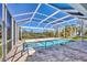 Enclosed pool area with a spa and a view of the neighborhood at 1141 Andrews St, Englewood, FL 34224