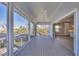 Large porch with screen and a peek into the bright kitchen of the house at 1141 Andrews St, Englewood, FL 34224
