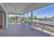 Large porch with screen and a great view of the backyard and a solar array at 1141 Andrews St, Englewood, FL 34224