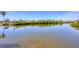 A view of the quiet water with a treeline along the opposite bank at 1141 Andrews St, Englewood, FL 34224