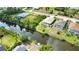 An aerial view displays the home, the backyard pool, and waterfront location at 116 Albatross Rd, Rotonda West, FL 33947