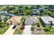 An aerial view shows the home's landscaping, driveway, and proximity to the canal at 116 Albatross Rd, Rotonda West, FL 33947