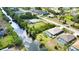 An aerial view captures a house with a pool, backing onto a canal in a residential neighborhood at 116 Albatross Rd, Rotonda West, FL 33947
