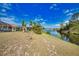 Expansive backyard showcasing in-ground pool with lake views, set within a screened enclosure at 116 Albatross Rd, Rotonda West, FL 33947