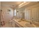 Bathroom featuring dual sinks, a large mirror, and a shower tub combination at 116 Albatross Rd, Rotonda West, FL 33947