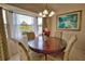 Bright dining area featuring a round table, comfortable chairs, and a large window with natural light at 116 Albatross Rd, Rotonda West, FL 33947
