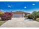 Charming single-story home boasting a two-car garage, long driveway, and mature landscaping at 116 Albatross Rd, Rotonda West, FL 33947