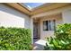 Inviting front entrance featuring a decorative glass door, window, and well-maintained landscaping at 116 Albatross Rd, Rotonda West, FL 33947