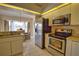 Modern kitchen with stainless steel appliances, bright lighting, and a view into the dining area at 116 Albatross Rd, Rotonda West, FL 33947