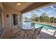 Enclosed lanai featuring a table and chairs with a pool view at 116 Albatross Rd, Rotonda West, FL 33947
