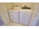 Image shows a laundry room with a side-by-side white washer and dryer at 116 Albatross Rd, Rotonda West, FL 33947