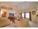 Bright and airy living room featuring neutral walls, modern furniture, a ceiling fan, and sliding door access at 116 Albatross Rd, Rotonda West, FL 33947