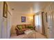 Cozy living room features a comfortable sofa, natural light from the window, and warm, inviting decor at 116 Albatross Rd, Rotonda West, FL 33947