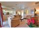 Bright, comfortable living room with neutral tones, ceiling fan, and views into the open-plan kitchen at 116 Albatross Rd, Rotonda West, FL 33947