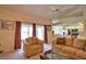 Comfortable living room featuring access to the kitchen, natural light, and a sliding glass door at 116 Albatross Rd, Rotonda West, FL 33947
