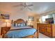 Main bedroom featuring wooden furniture, a ceiling fan, and lamps at 116 Albatross Rd, Rotonda West, FL 33947