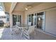 Covered patio features dining table and chairs with access to the interior through sliding glass doors at 116 Albatross Rd, Rotonda West, FL 33947