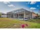 Back of home featuring screened-in pool and patio with comfortable outdoor seating at 116 Albatross Rd, Rotonda West, FL 33947