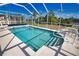 Inviting in-ground pool with a screened enclosure, surrounded by well-maintained landscaping at 116 Albatross Rd, Rotonda West, FL 33947