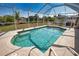 Screened-in pool surrounded by patio and lawn; a perfect spot to relax and enjoy the outdoors at 116 Albatross Rd, Rotonda West, FL 33947