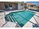 Sparkling in-ground pool with screened enclosure, surrounded by patio seating and well kept landscaping at 116 Albatross Rd, Rotonda West, FL 33947