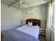 Cozy bedroom featuring a comfortable bed with a decorative headboard and bedside lamps at 1270 Gulf Blvd # A&B, Englewood, FL 34223