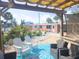 Inviting outdoor patio with ample seating, featuring a charming bungalow with colorful accents and well-manicured landscaping at 1270 Gulf Blvd # A&B, Englewood, FL 34223