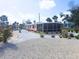 Charming single-story home featuring a spacious, well-maintained gravel yard and enclosed porch at 1270 Gulf Blvd # A&B, Englewood, FL 34223