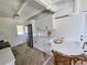 Modern kitchen featuring stainless steel appliances, white cabinetry, and a cozy breakfast nook at 1270 Gulf Blvd # A&B, Englewood, FL 34223