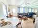 Comfortable living room with stylish furniture, beamed ceiling, and ample natural light at 1270 Gulf Blvd # A&B, Englewood, FL 34223