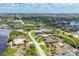 Aerial view of property in a neighborhood with mature trees and landscaping at 14527 Maysville Cir, Port Charlotte, FL 33981