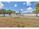 Large backyard with shed and RV parking area, enclosed with white picket fencing at 14527 Maysville Cir, Port Charlotte, FL 33981