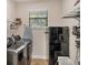 Convenient laundry room with washer, dryer, storage shelves, and additional refrigerator at 14527 Maysville Cir, Port Charlotte, FL 33981