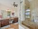 Updated main bathroom featuring dual sinks, walk-in shower, and granite countertops at 14527 Maysville Cir, Port Charlotte, FL 33981