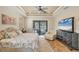 Comfortable main bedroom with a ceiling fan, recessed lights, and television at 14527 Maysville Cir, Port Charlotte, FL 33981