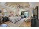 Relaxing main bedroom featuring tray ceiling, ceiling fan, and lanai access at 14527 Maysville Cir, Port Charlotte, FL 33981