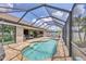 Relaxing screened pool with brick pavers and lounge area; perfect for enjoying the Florida sunshine at 14527 Maysville Cir, Port Charlotte, FL 33981