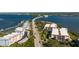 Aerial view of waterfront condos, bridge, and lush landscaping, offering stunning coastal living and waterway access at 1551 Beach Rd # 412, Englewood, FL 34223
