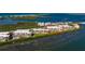 Aerial view of bayfront condos with stunning views, a community pool, and lush landscaping at 1551 Beach Rd # 412, Englewood, FL 34223
