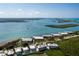 Aerial view of coastal condos on bay, with turquoise waters, island views, and blue skies at 1551 Beach Rd # 412, Englewood, FL 34223