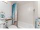 Bright bathroom with a white tiled shower and stylish blue shower curtain at 1551 Beach Rd # 412, Englewood, FL 34223