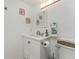 Well-lit bathroom with a white vanity, decorative mirror, and coordinated accessories at 1551 Beach Rd # 412, Englewood, FL 34223