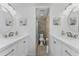 Bright bathroom with double sinks, shower and decorative artwork at 1551 Beach Rd # 412, Englewood, FL 34223