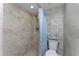 Shower featuring tile surround, a shower curtain and built-in shelving at 1551 Beach Rd # 412, Englewood, FL 34223